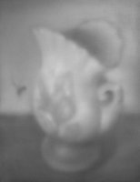 Bee distracted by painted flowers on a vase